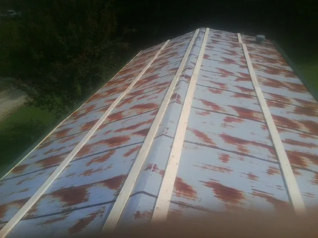 Rusted metal roof panels with new wood purlins before replacement — Storm Damage Roof Repair in Belden by Roofing Brothers